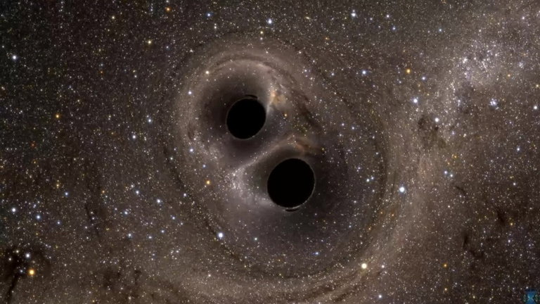 Este "abrazo" de dos agujeros negros nos permite estudiar cómo podría ser el fin de nuestra propia galaxia